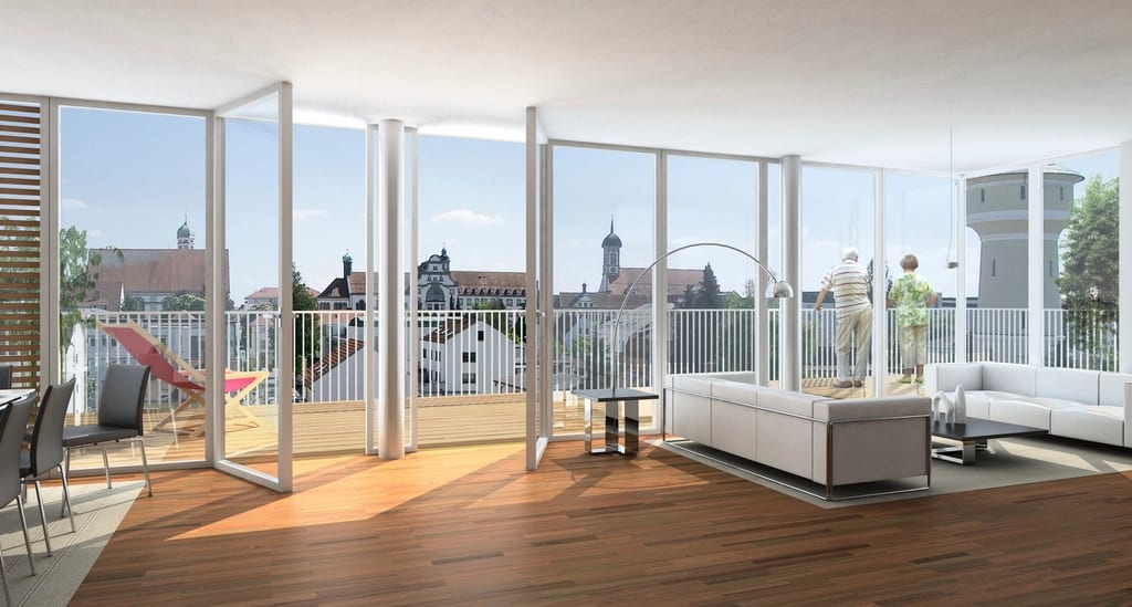 A bright, empty flat with tall windows opening onto a balcony and rooftops